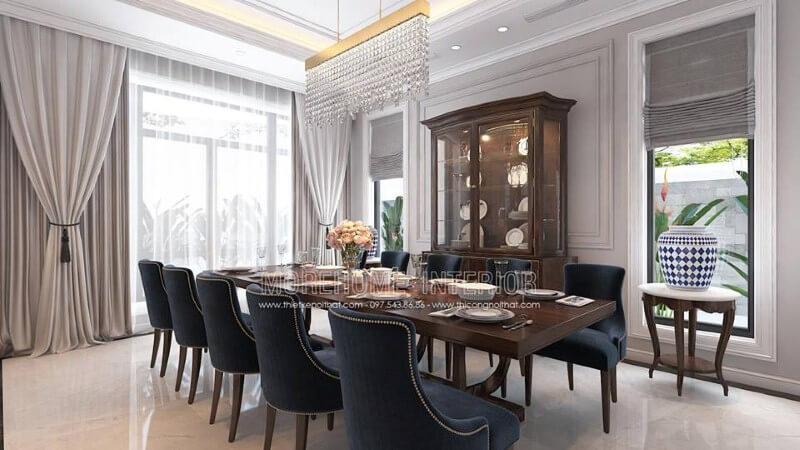 Trang trí nội thất phòng ăn gỗ óc chó tân cổ điển đẹp, sang trọng từ bàn gỗ nguyên khối, ghế bọc nệm cao cấp, kệ, tủ kệ trang trí. Thiết kế biệt thự