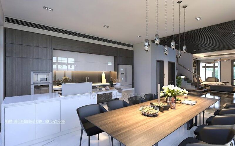 Bàn ăn gỗ nguyên tấm mộc mạc kết hợp đồ nội thất hiện đại sẽ là lựa chọn ấn tượng tạo nên không gian độc đáo cho phòng ăn liền bếp. thiết kế biệt thự