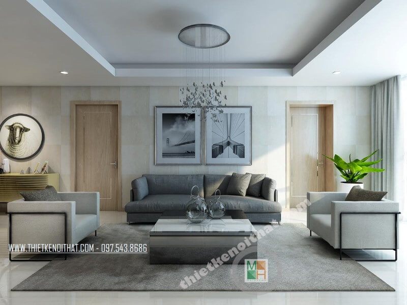 Bộ sofa bọc vải cao cấp với chiếc ghế sofa dài màu xám và hai ghế đơn màu xám tạo điểm nhấn nổi bật cho phòng khách chung cư
